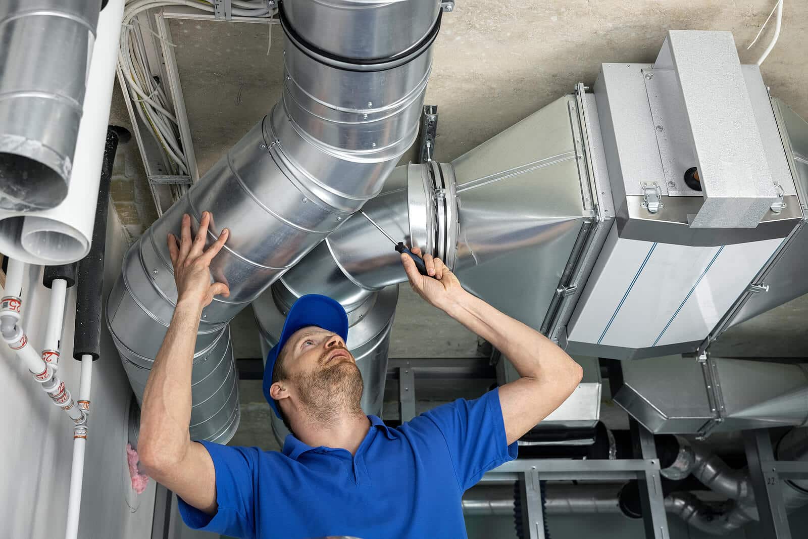 HVAC technician inspecting and repairing air ducts in Carson