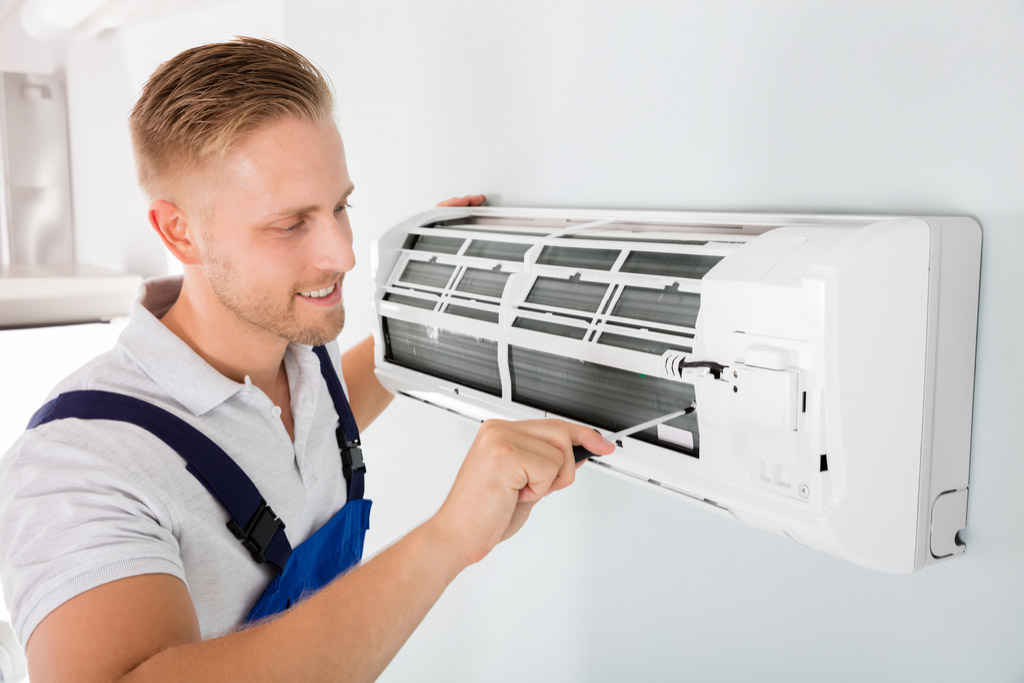 HVAC technician maintaining a ductless air conditioner in Carson