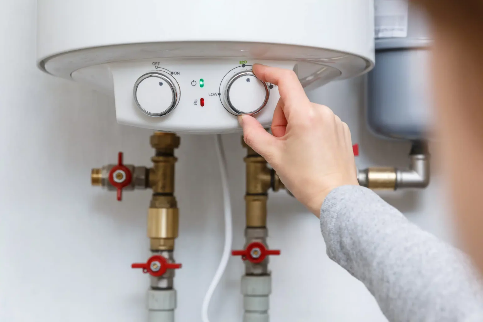 Technician adjusting a water heater in Carson